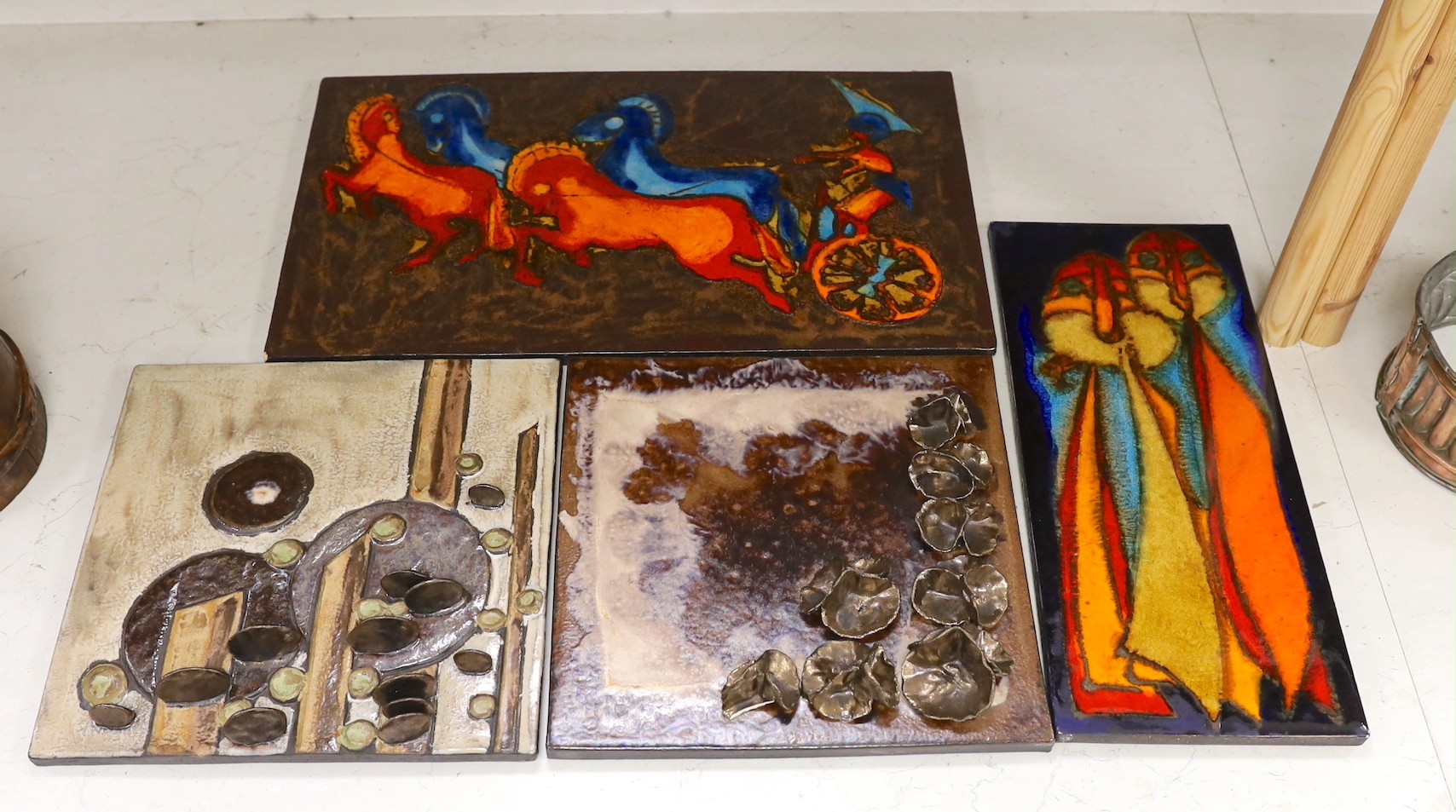 Two West German Ruscha pottery wall plaques and two studio pottery metallic glazed plaques. Largest 35x60cm